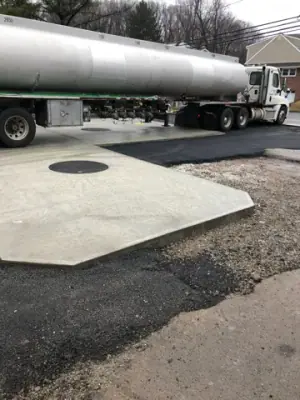 Fuel tanker beside the concrete tank-access pad.