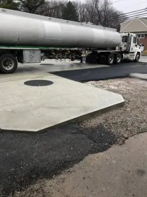Fuel tanker beside the concrete tank-access pad.