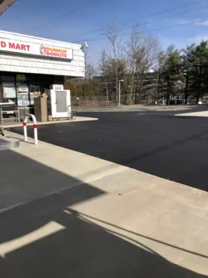 New asphalt beside the convenience-store entrance.