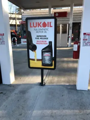 Lukoil promotional sign on the concrete fueling apron.