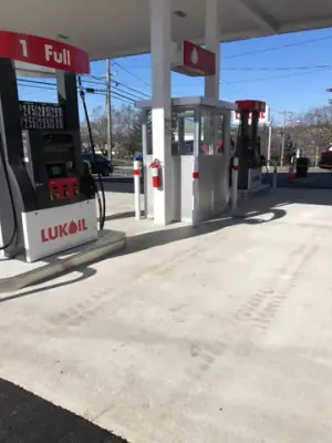 Installed dispensers and attendant booth beneath the canopy.