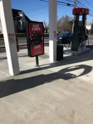 Dispenser lane and promotional sign beneath the canopy.